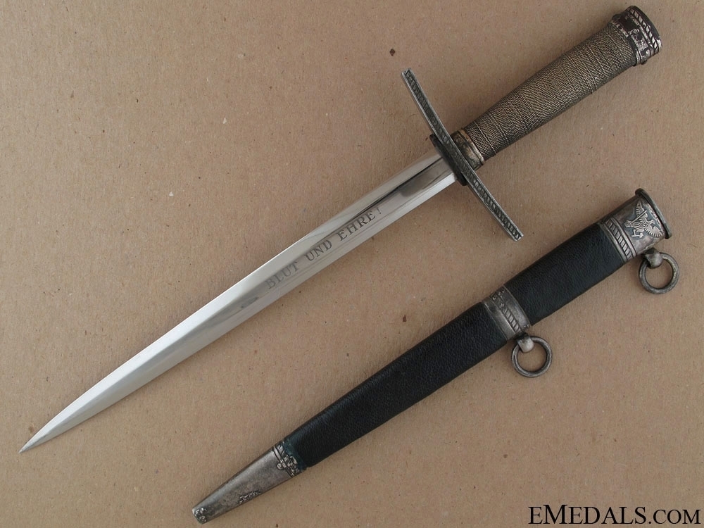 A dagger M 37 for Hitler Youth leaders, with hanger. Maker M7/36, E & F  Hörster, Solingen. Plated blade, the obverse side etched with the motto  Blut und Ehre! (Blood and Honour!).
